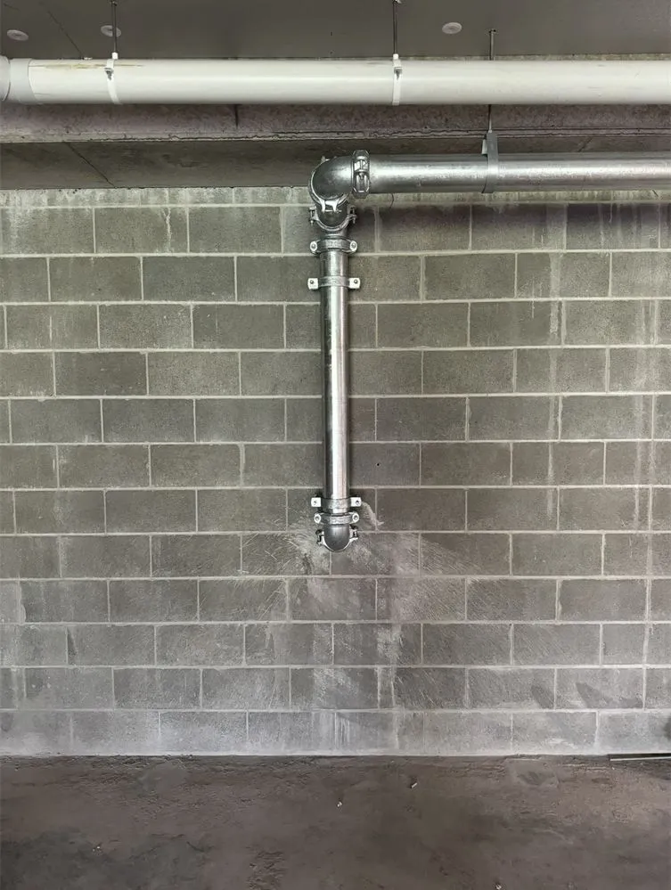 Commercial plumbing rough-in against a block wall