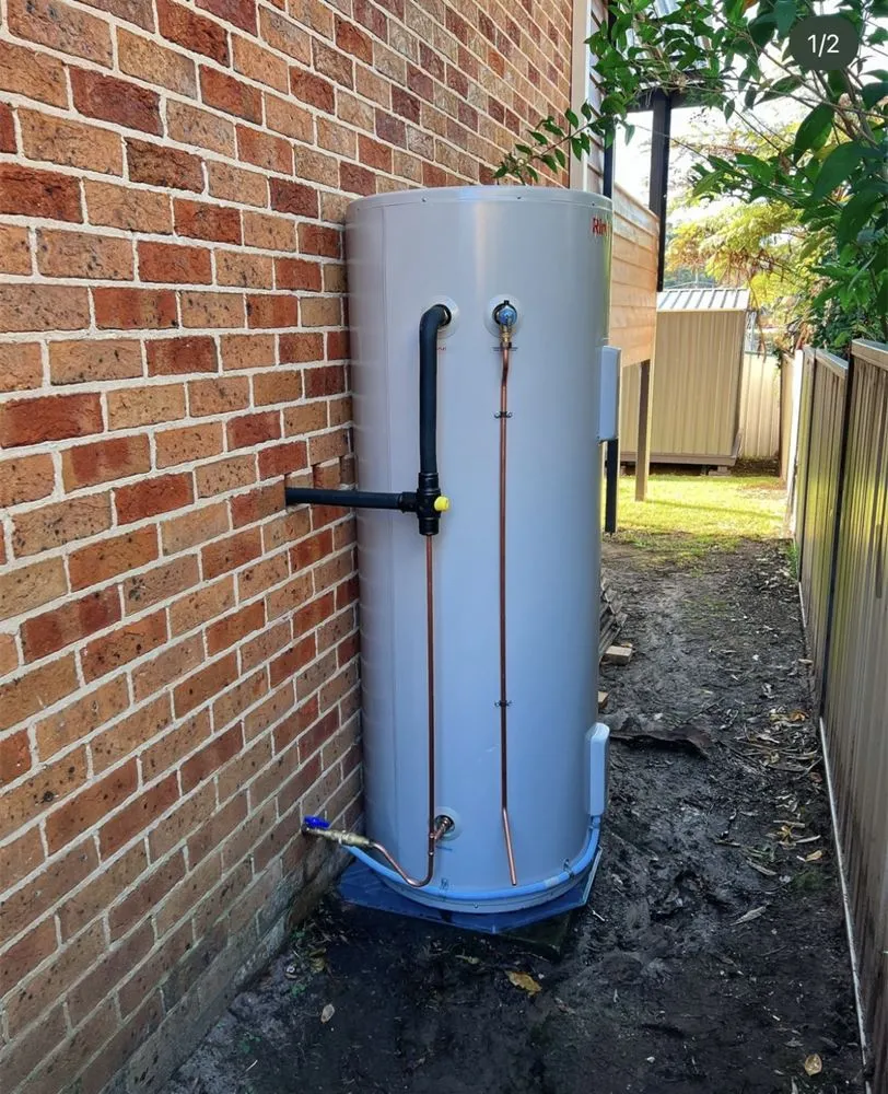 Hot water cylinder installed beside a brick unit
